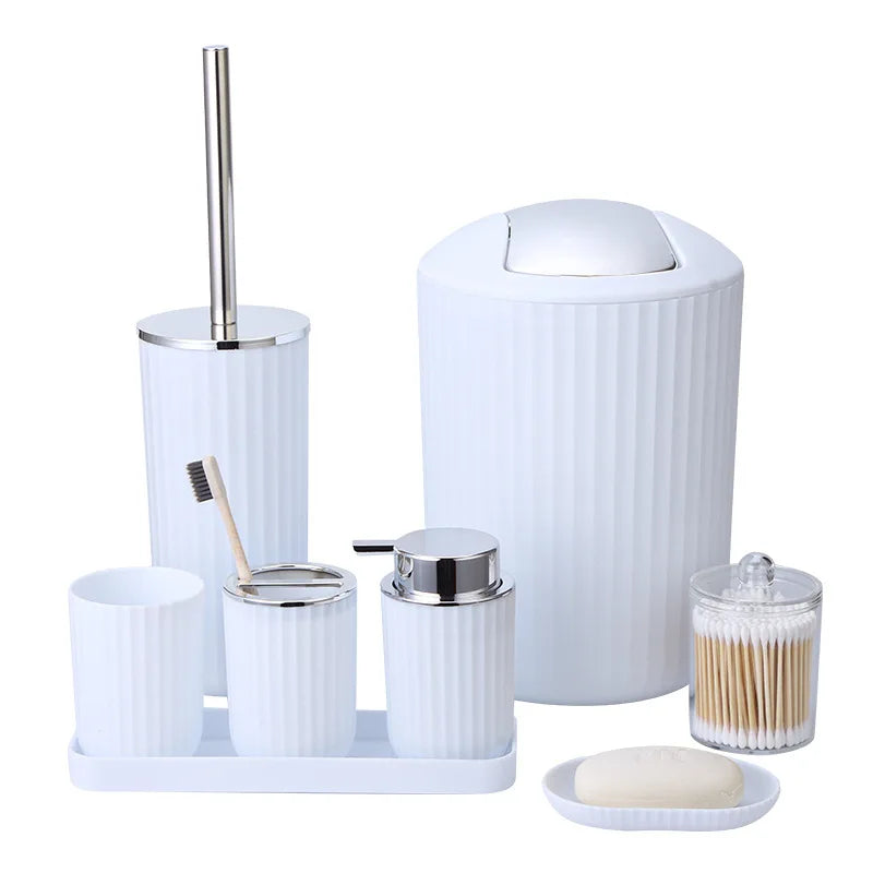 Bathroom accessory set with white containers and silver accents on a white background